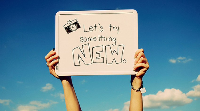 Whiteboard with "Let's try something NEW"